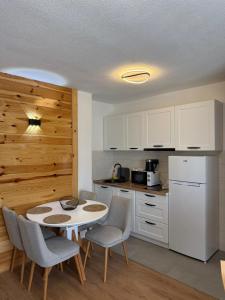 a kitchen with a table and chairs in a room at Apartments S&S in Žabljak