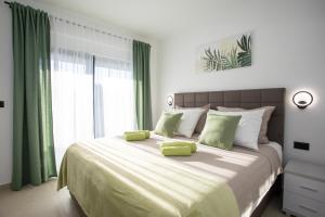 a bedroom with a large bed with green accents at Villa Vox in Labin