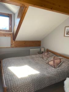 a bedroom with a bed in a attic at Cosy d'Asmae in Ustou