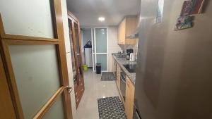 a small kitchen with a counter and a hallway at Ale Galicia in Cambre