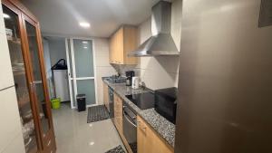 a small kitchen with a sink and a stove at Ale Galicia in Cambre