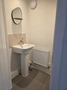 a bathroom with a sink and a mirror on the wall at HomeAway Comfort in Minster