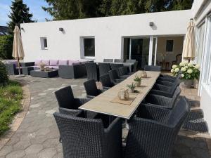 a long table with chairs and a tableasteryasteryasteryasteryasteryasteryasteryastery at Haus der alten Bäume - Retreathaus Hillesheim in Hillesheim