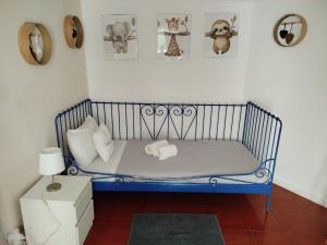 a blue crib in a room with pillows at Casa dos Marias in Elvas +9 photos