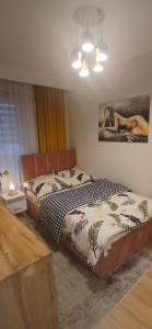a bedroom with a bed and a painting on the wall at Apartament Euro 2 Kraków in Krakow
