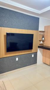 a large flat screen tv on a wall at Loft Completo Compact in Palmas