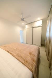 a bedroom with a large bed and a sliding door at Casa Iturraspe in Reconquista