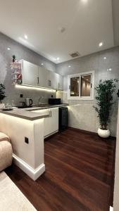a kitchen with a sink and a counter top at Luxury apartment jeddah in alrawdah 6 Near the airport in Jeddah +15 photos