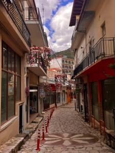 an empty street with orange cones in a town at B & G's LOFT in Karpenisi