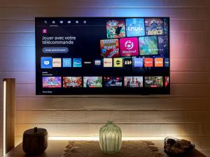 a flat screen tv hanging on a wall at L'authentique chalet en bois sur pilotis in Gruissan +19 photos