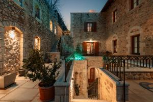 a stone building with a staircase in front of it at Μikri Arktos Boutique Hotel in Dimitsana