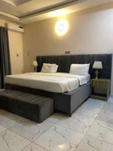 a large bed in a room with a large bed sidx sidx sidx at Lynstel Apartment & Suites in Abuja