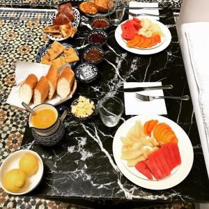 a table with plates of different types of food at Riad chak chak suite & spa in Fez