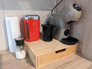 a shelf with a coffee maker and a blender on it at K&K City-Apartment in Weimar