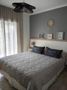 a bedroom with a large bed with blue pillows at Amarras pinamar in Pinamar +32 photos