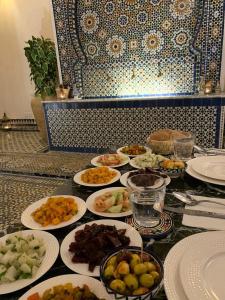 a table with many plates of food on it at Riad chak chak suite & spa in Fez