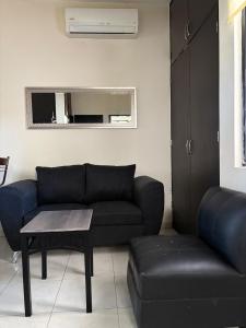 a living room with a couch and a table at Comfortable 1BR Apartment 10 Min from Malecón in La Paz