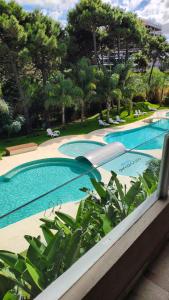a view of two swimming pools in a resort at Amarras pinamar in Pinamar