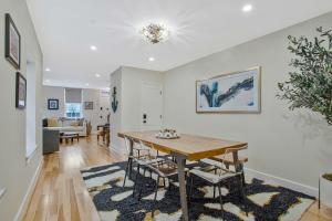 a dining room and living room with a table at Luxe Row Home Steps to USNA Gate 3 in Annapolis
