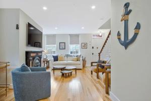 a living room with a couch and a table at Luxe Row Home Steps to USNA Gate 3 in Annapolis