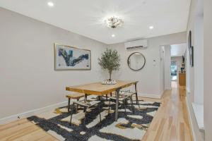 a dining room with a table and a vase at Luxe Row Home Steps to USNA Gate 3 in Annapolis +27 photos