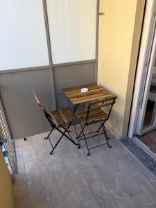 ein Holztisch und ein Stuhl auf einer Veranda in der Unterkunft Gianduia in Turin + 12 Fotos