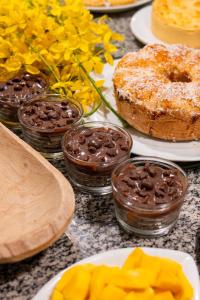 a table topped with plates of pastries and desserts at Hotel do Pescador in Morro de São Paulo +59 photos