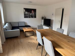 a living room with a wooden table and a couch at Ferienhaus von Werner in Schlatt