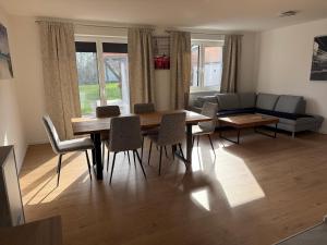 a living room with a table and chairs and a couch at Ferienhaus von Werner in Schlatt