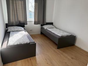 two beds in a room with a window at Ferienhaus von Werner in Schlatt