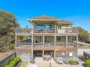 a large house with a deck and patio at The Sand Wedge in Kitty Hawk