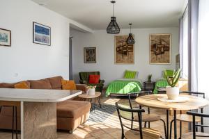 a living room with a couch and tables at Dom Czajka nad Jeziorem Wigry in Stary Folwark