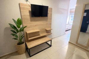 a living room with a tv on a wall at HOTEL MEDELLIN CENTRAL in Medellín +17 photos