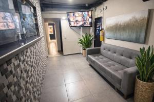 a waiting room with a couch and a sink at HOTEL MEDELLIN CENTRAL in Medellín