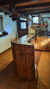 a kitchen with a large wooden island in a kitchen at Casa Rongia in Faido