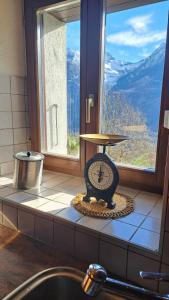 a clock sitting on a counter in front of a window at Casa Rongia in Faido +39 photos