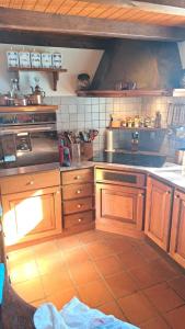 a kitchen with wooden cabinets and a stove at Casa Rongia in Faido