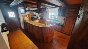 a kitchen with a large wooden island in the middle at Casa Rongia in Faido