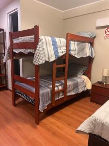 a couple of bunk beds in a room at Hotel Makita in Muquiyauyo