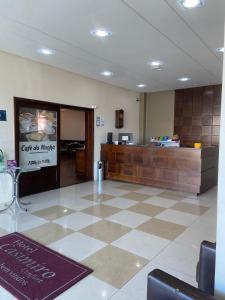 a lobby with a cash register and a restaurant at Hotel Casimiro in Ponta Grossa