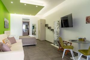 a living room with a couch and a table at Geranium B&B in Bitonto