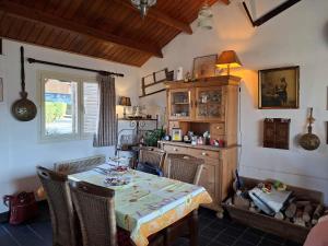 a dining room with a table and chairs in a room at Vakantiehuis Malaika in Rendeux