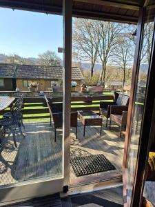 a screened in porch with a view of a patio at Vakantiehuis Malaika in Rendeux