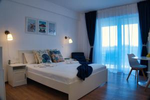 a bedroom with a bed and a table and chairs at Zen Studio Olimp Poolside in Olimp