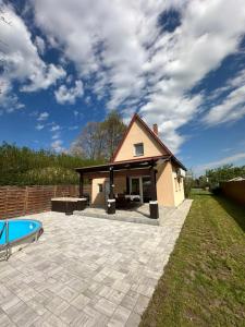 a house with a patio and a swimming pool at KörösPartOn in Békésszentandrás