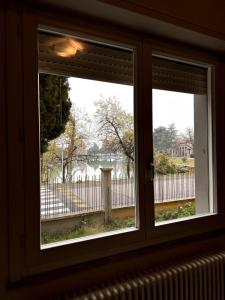 a window with a view of a fence at Casa Clube Mantova in Mantova