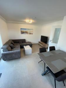 a living room with a couch and a table at Seeidylle in Geeste