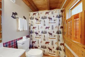 a bathroom with a shower curtain with horses on it at Napping Bear Cabin in Banner Elk +20 photos