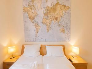 a room with two beds and a map on the wall at Appartement Peter in Freyung im Bayerischen Wald in Freyung +32 photos