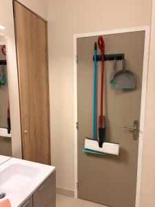 a bathroom with a door with some tools on it at Ninon et ses sommets in Cauterets